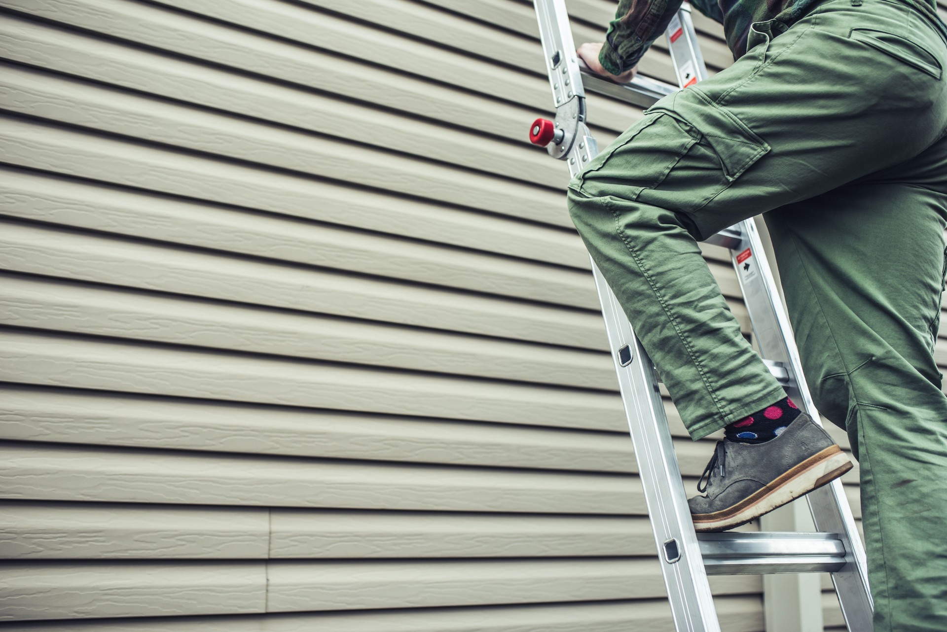 man climbing ladder for siding installation in clarksburg west virginia