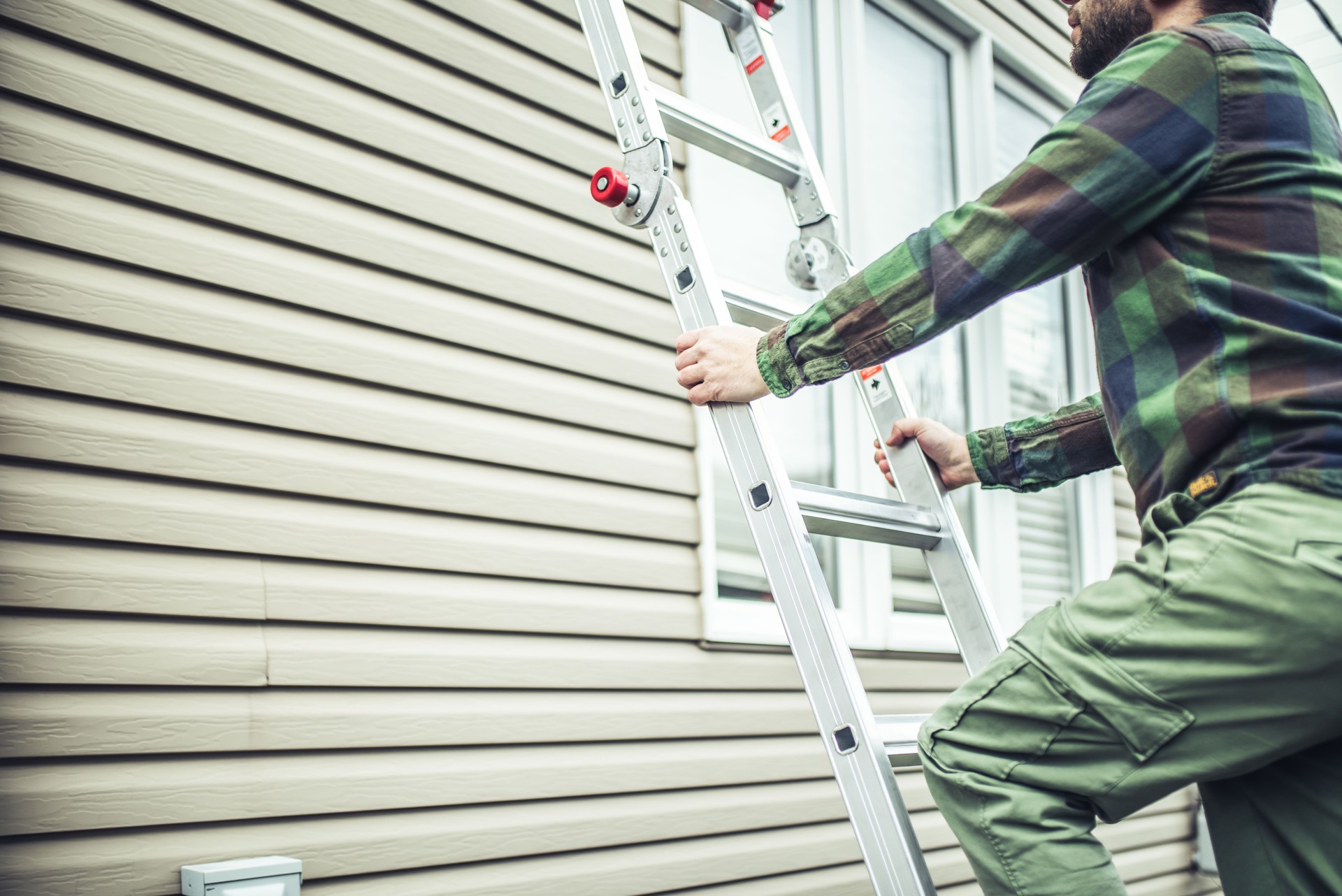 man climbing ladder for siding installation in clarksburg west virginia