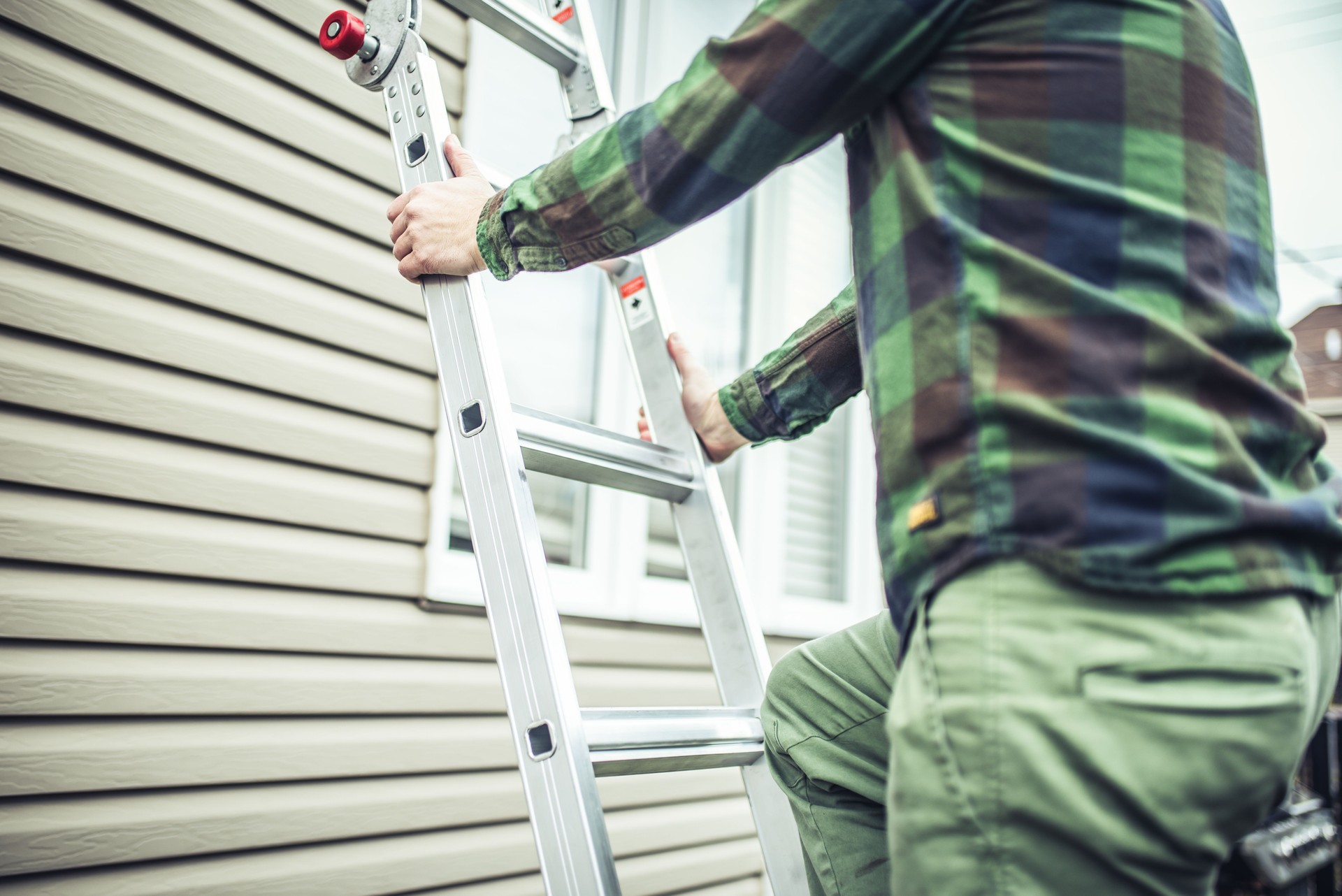 man climbing ladder for siding installation in clarksburg west virginia